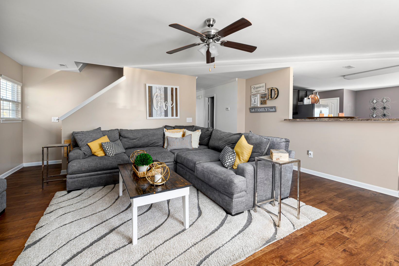Living Room with Gray Sofa and Ceiling Fan 