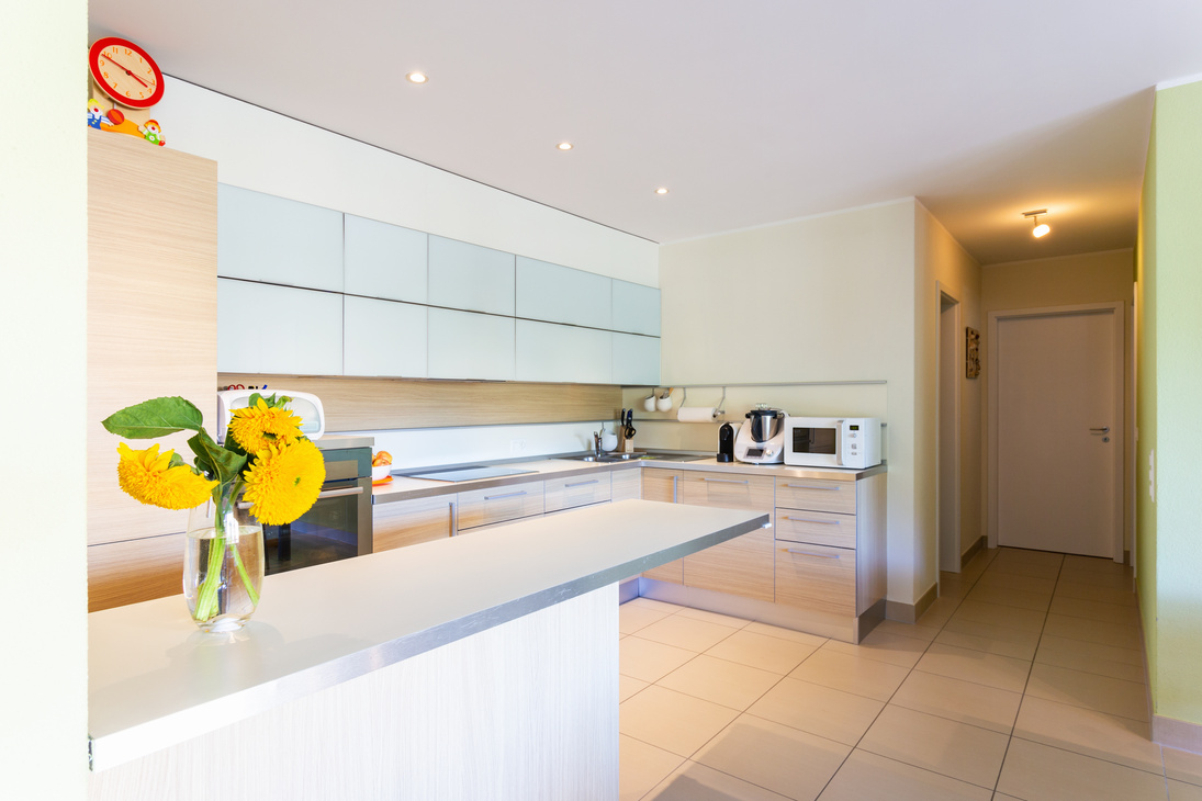 Kitchen with peninsula and yellow flowers